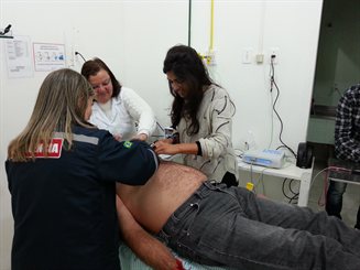 eHealth activities at Sao Jose Hospital in Palmares do Sul city: Photo-ECG (telecardiology) and teledermatology studies (Fizza is on the right)