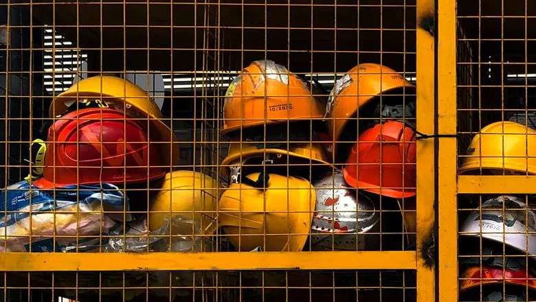 Hard hats in a cage. 