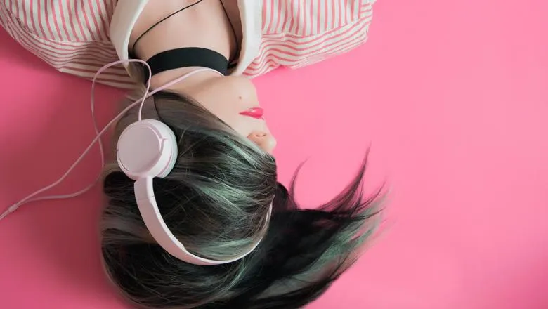 Music Generations in the Digital Age book cover fragment showing a person wearing headphones against pink background