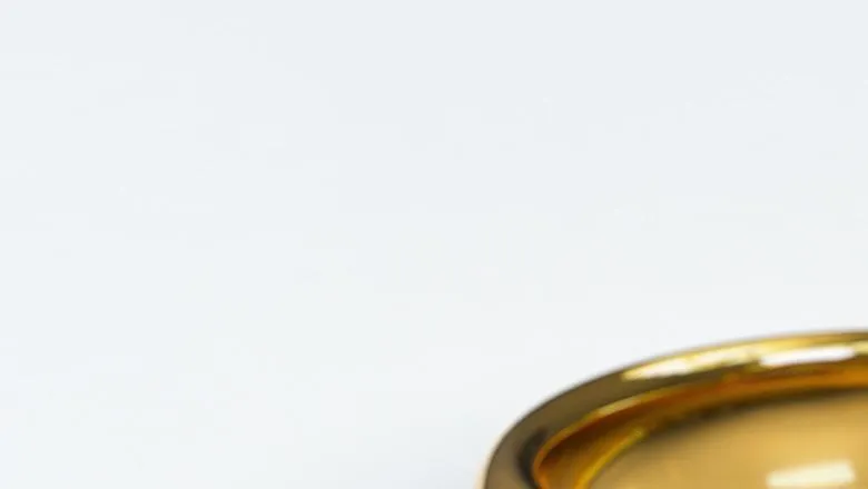 Two Gold Wedding Rings against a white background