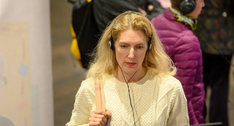 Woman at exhibition using an audioguide.