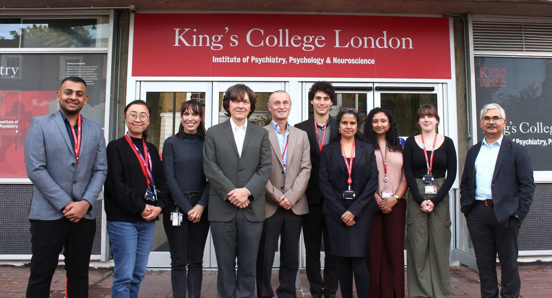 A photograph of a group of researchers standing in front of the King's College London IoPPN building 