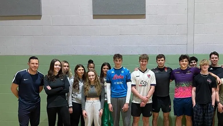 Ross Edmonds with TASS Student-Athletes in Sports hall