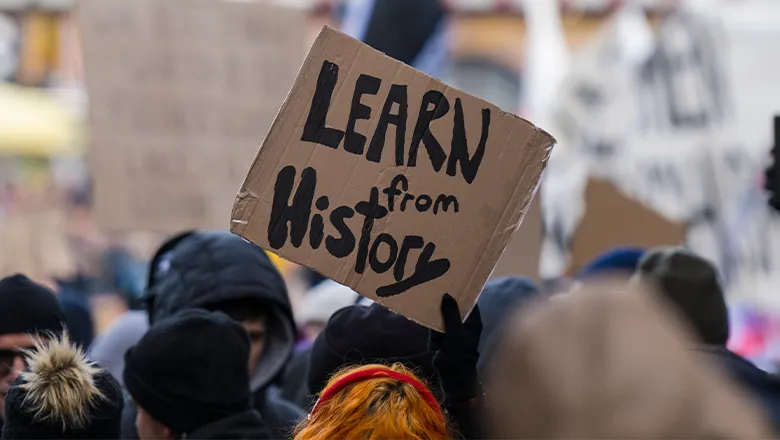 Anti fascist demostration in Germany with placard saying learn from history