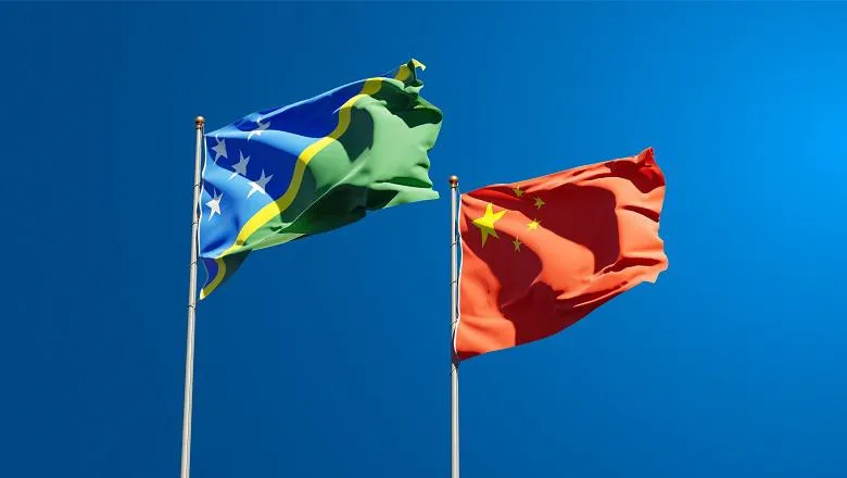 National flags of China and the Solomon Islands at full mast
