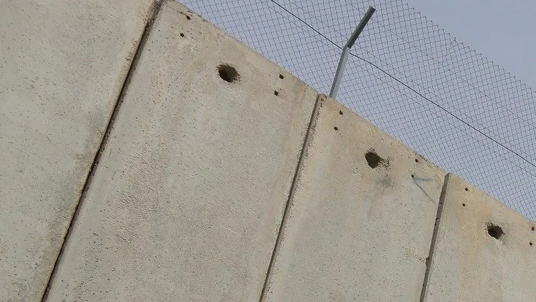 A border wall between Israel and the West Bank.