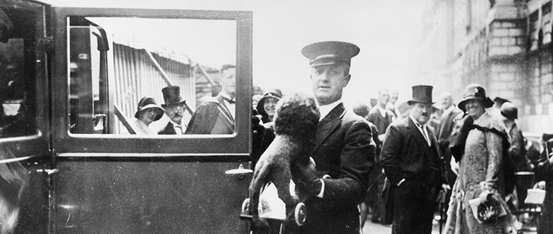 Man holding the toy Reggie the lion that was presented to the infant Princess Elizabeth in 1926.