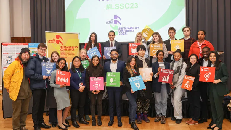 A group of students holding up SDG boards during the LSSC networking. 