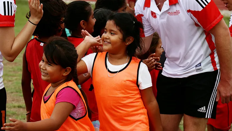 Girls playing football.