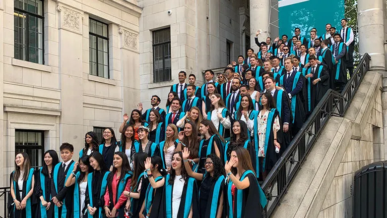The Economics & Management Class of 2019 assembles for a class photo on the step in the Bush House East Courtyard.