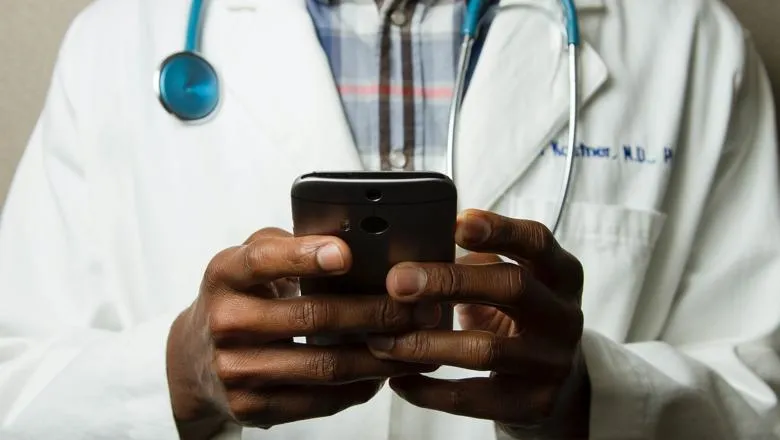 A picture of a doctor holding a smartphone