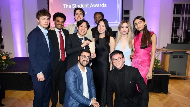 10 diverse young people in smart clothes pose for a group photo