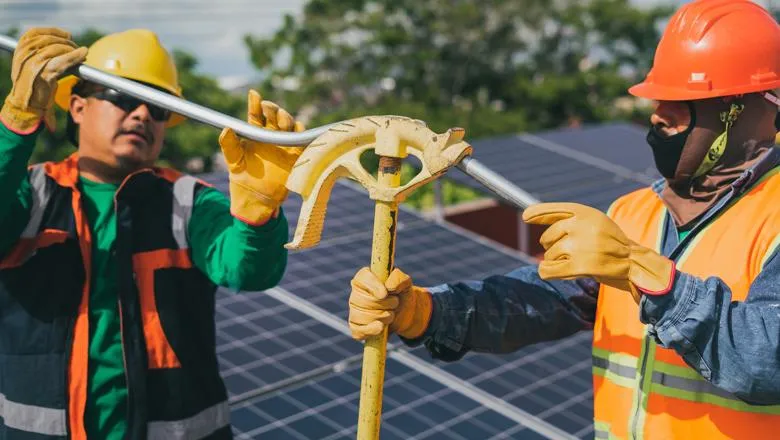 Two men fixing a solar panel