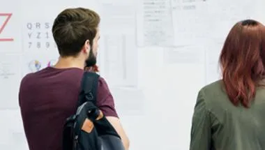 Two people looking at research posters