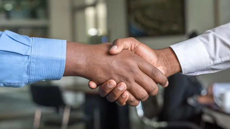 Two hands grasping each other in trust.