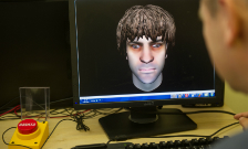 Man looking at computer screen showing avatar
