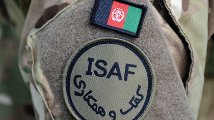 Close-up of Royal Marine's arm featuring ISAF badge