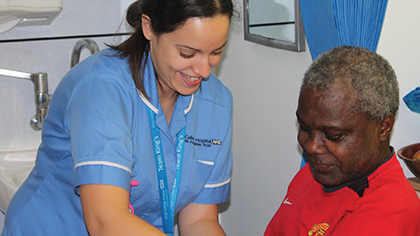 Female nurse testing male patient's blood pressure