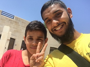 Enam Ahmod with a kid from Syria