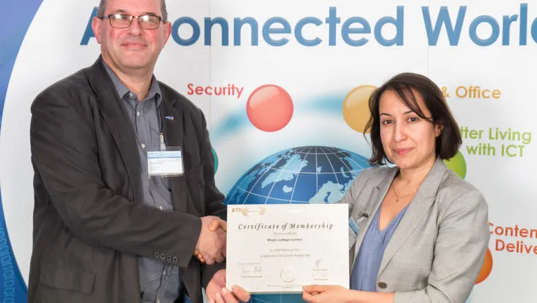 Dr Toktam Mahmoodi, receiving the membership certificate from Mr. Simon Hicks.