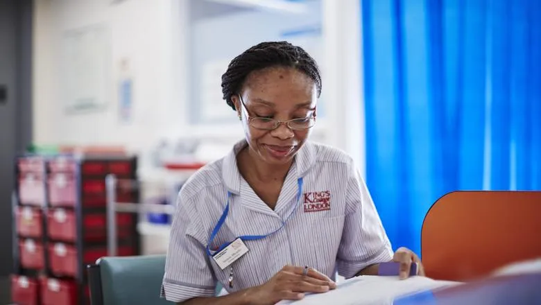 Student nurse sitting at desk with paperwork