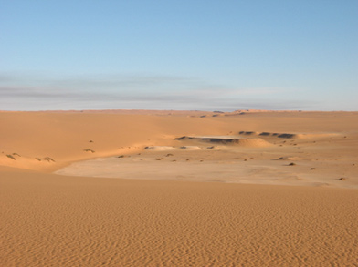 Terraces of palaeolake sediments outcropping in an inter-dune basin in the Ubari Sand Sea