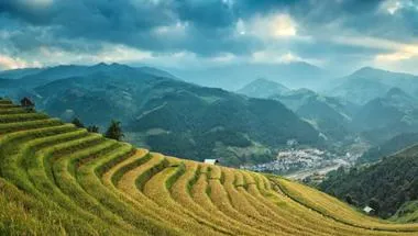 cloudy countryside cropland farm around mountains