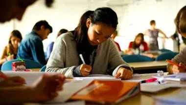 A school student writing in class