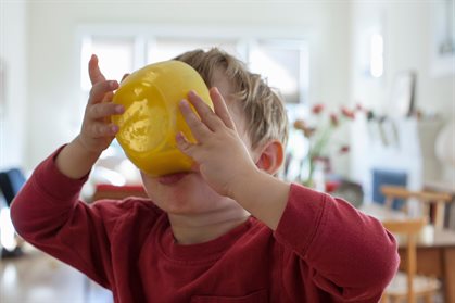 F0191655-Young_boy_holding_yellow_breakfast_bowl_up_to_his_mouth