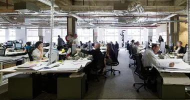 People working at desks in open-plan office environment