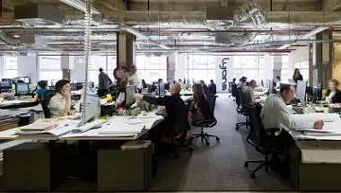 People working at desks in open-plan office environment