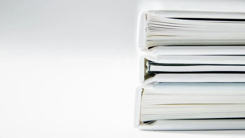 Stack of white hardback books