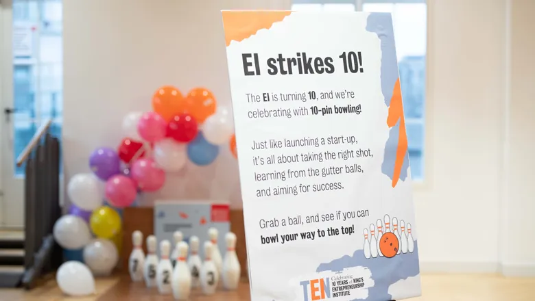 Signage with balloons in the background