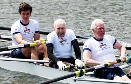 Image of Dr Francis de Marneffe and crew members past and present during a row past at Henley Royal Regatta