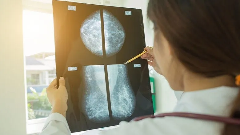 doctor looks at breast screening image