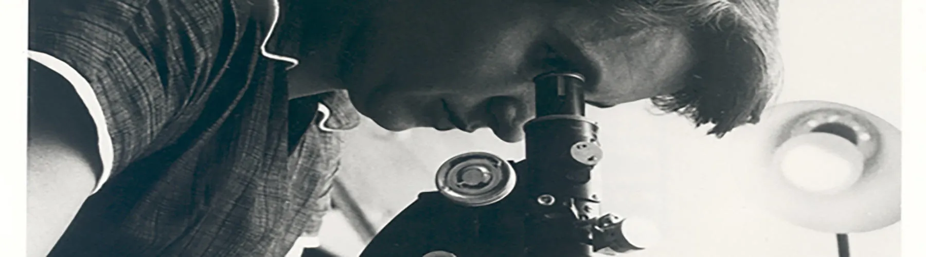 Dr Rosalind Franklin uses a microscope