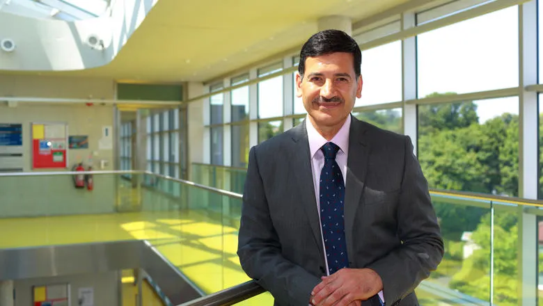 Professor Bashir M. Al-Hashimi leaning on a railing