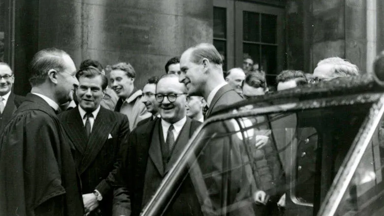 Prince Philip greets members of the King’s community, including Principal Sir Peter Noble (right) and The Dean Canon Eric Symes Abbott (left), at King’s in December 1955. Image: King's College London Archives.
