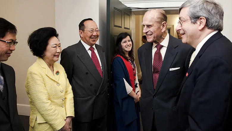 Prince Philip is introduced to guests by Principal Sir Rick Trainor (right) during the opening of Somerset House East Wing in 2012. Image: Greg Funnell.
