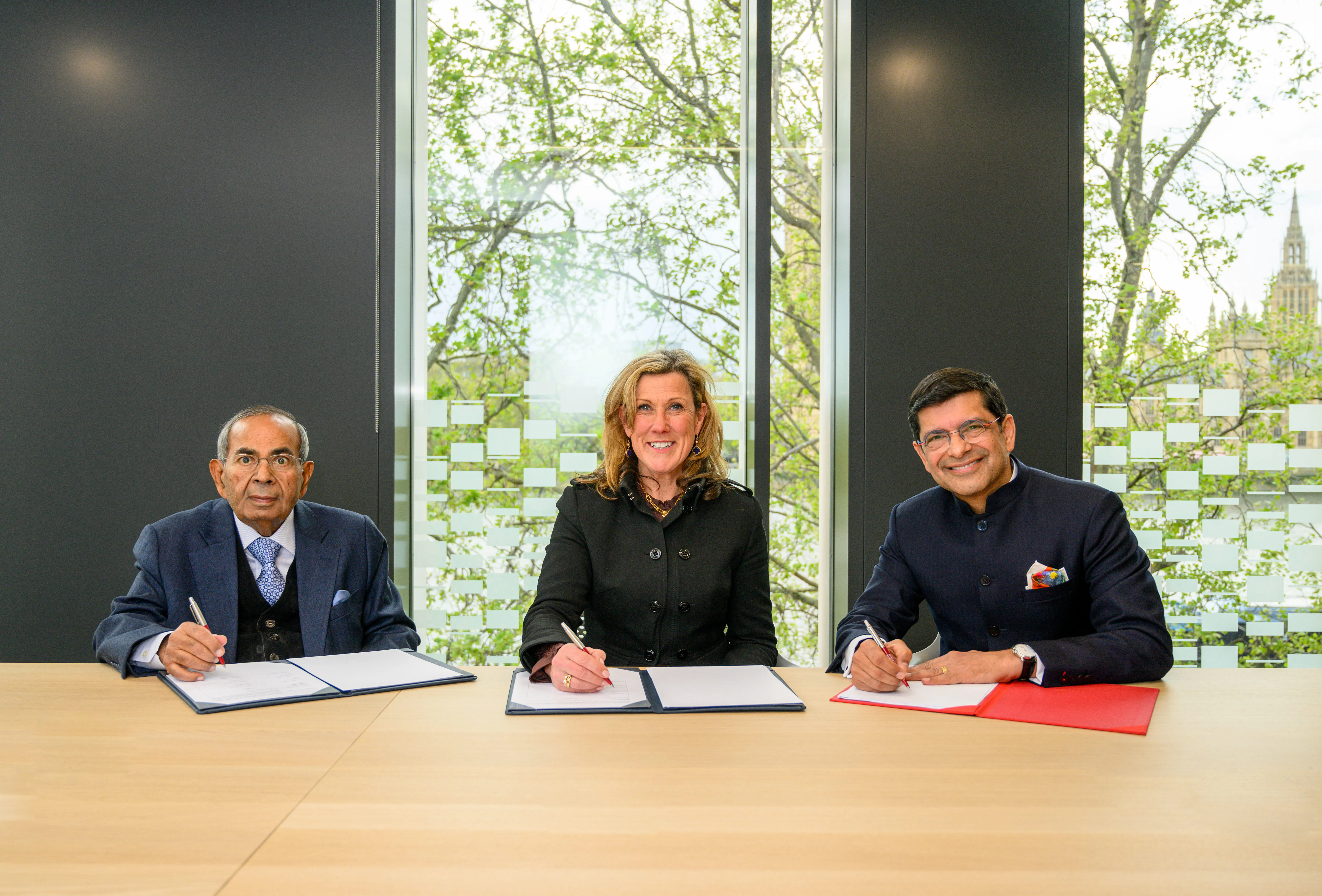 Gopichand Hinduja, Professor Shitij Kapur (Vice-Chancellor and President King's College London) and  Dr Claire Mallinson (Director of Medical Education, King's Health Partners and Consultant Anaesthetist, Guy's and St Thomas' NHS Foundation Trust) signing the MoA