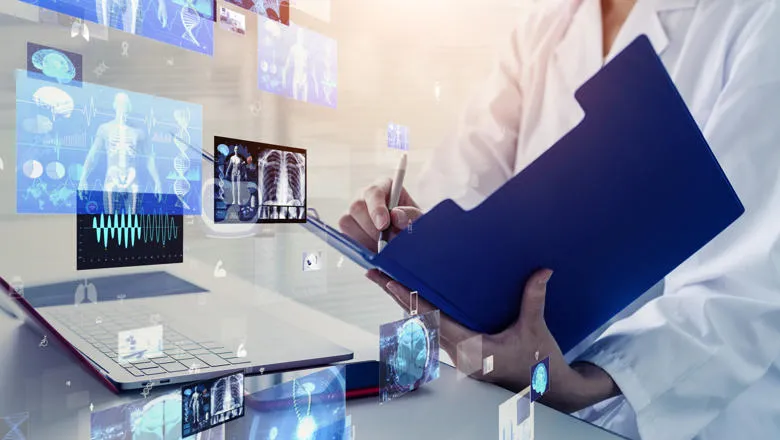 Scientist with laptop clipboard and display of human anatomy