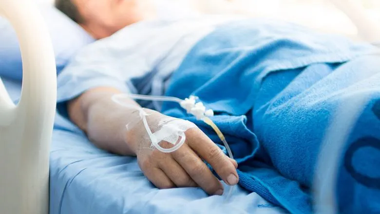 A person lying in a hospital bed.