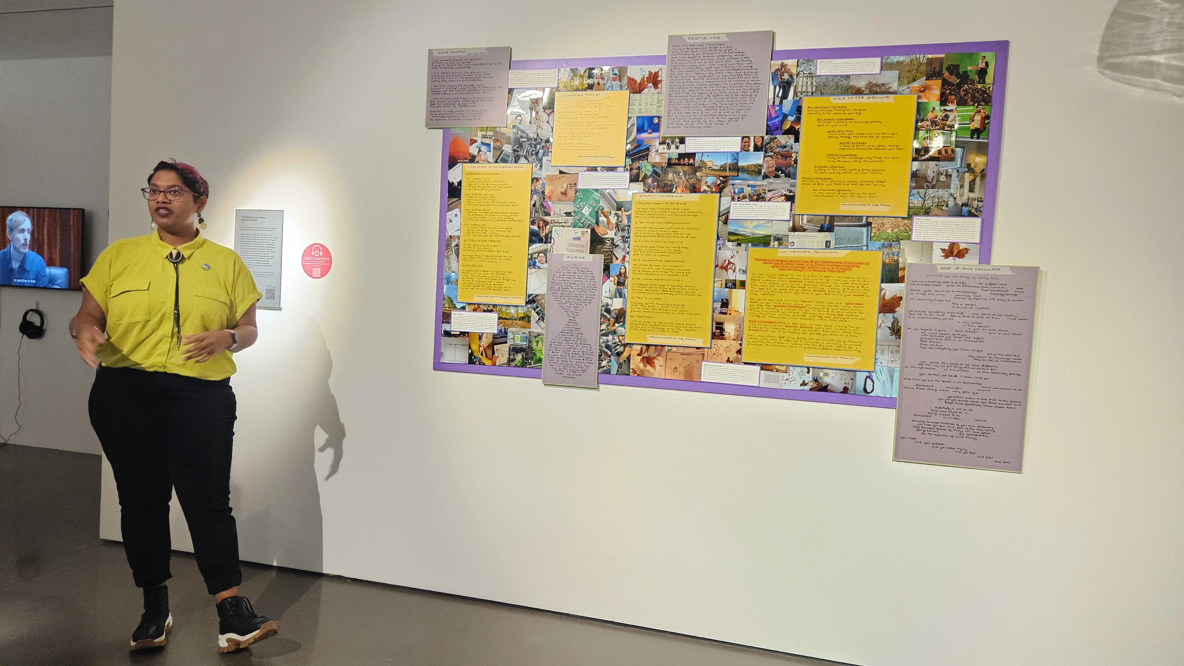 Woman standing in front of art talking