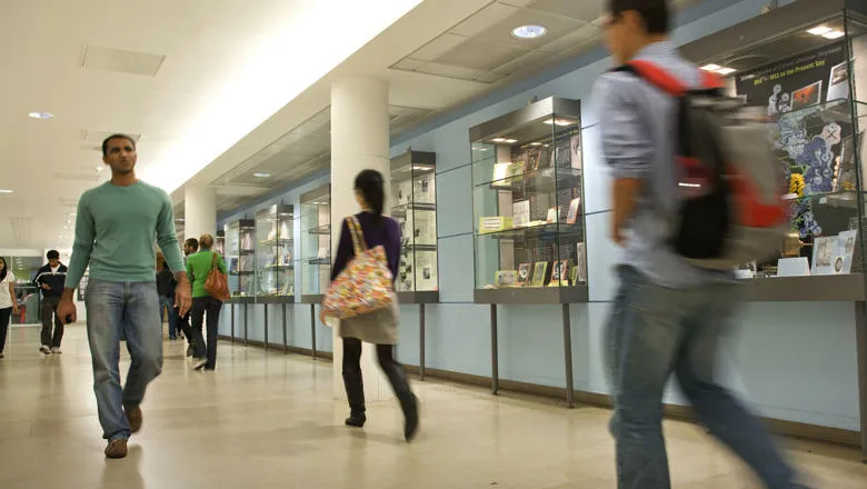 Students walking through a corridor on campus