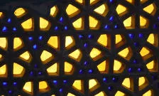Image of stained glass with yellow and blue patterns.