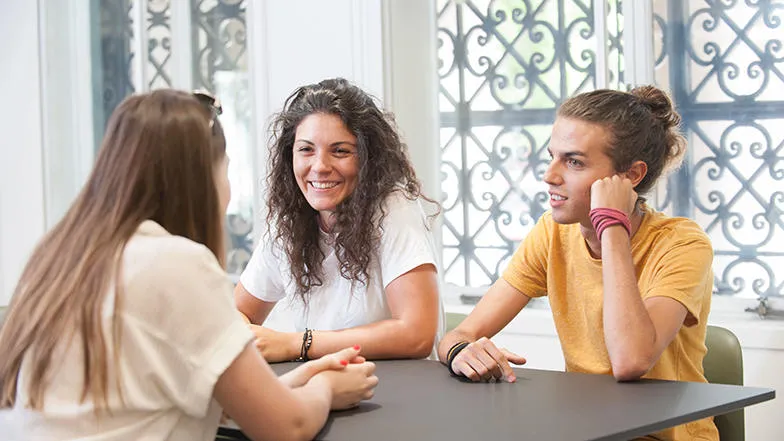 Three students chatting