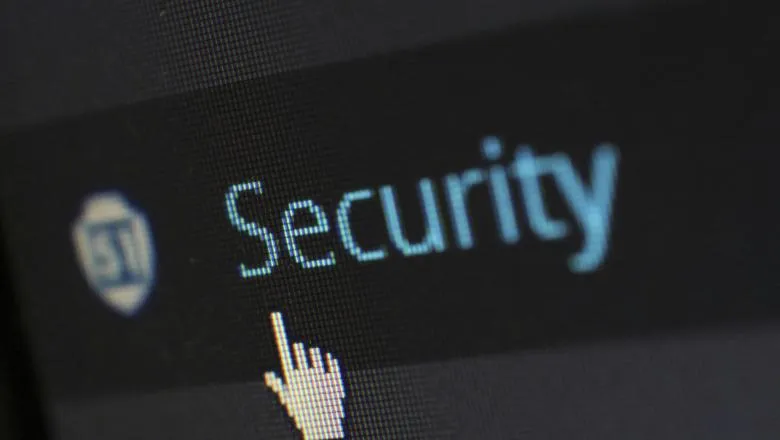 A mouse finger pointer pointing at the word 'Security' on a computer screen
