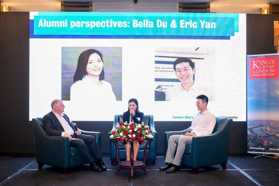Kerry Brown, Bella Du and Eric Yan hold a conversation on a stage in front of a large screen