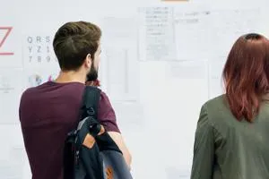 Two people looking at research posters