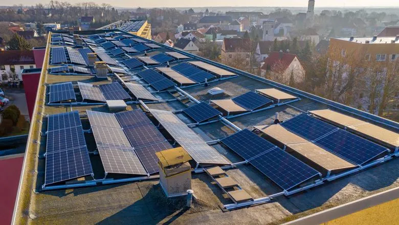 Solar panels on rooftop overlooking small town
